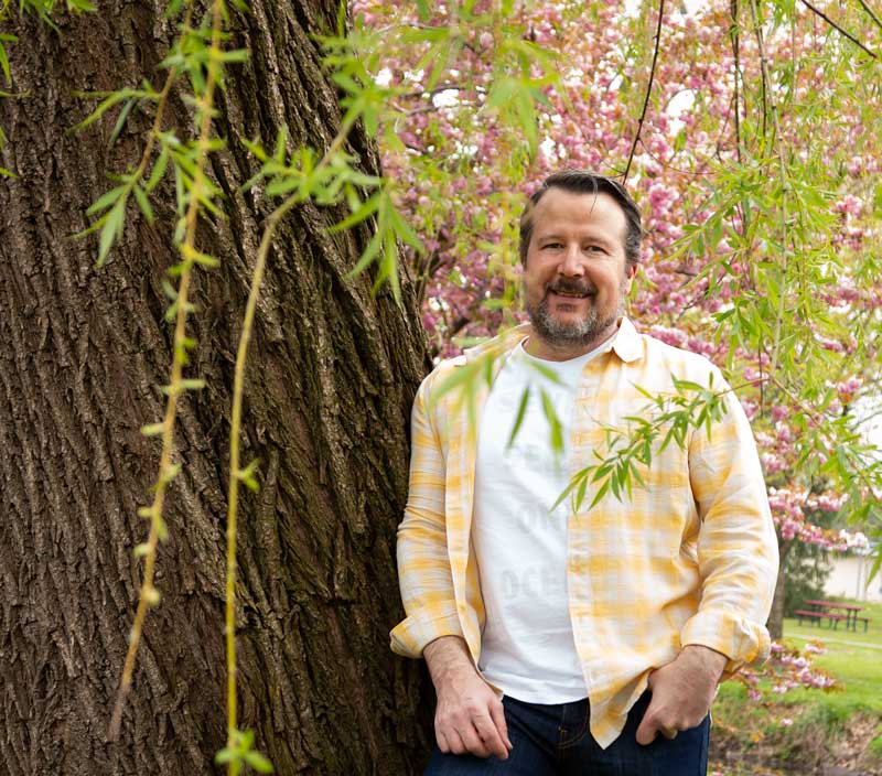 CIEL's Scott Thomas Fischer wearing Levi's Wellthread jeans, linen shirt, and cotton T-shirt from Outerknown Apparel